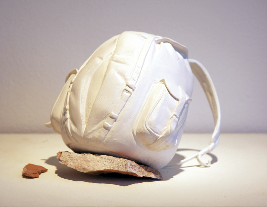 Melanie Vote sculpture: Backpack (2011) plaster, magic sculpt, found rock 6x6x6 in.