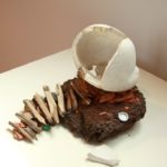 Melanie Vote: Head as Home (2010), maquette: unfired porcelain, cow pie, wood, other found materials, 10x10x12 in.