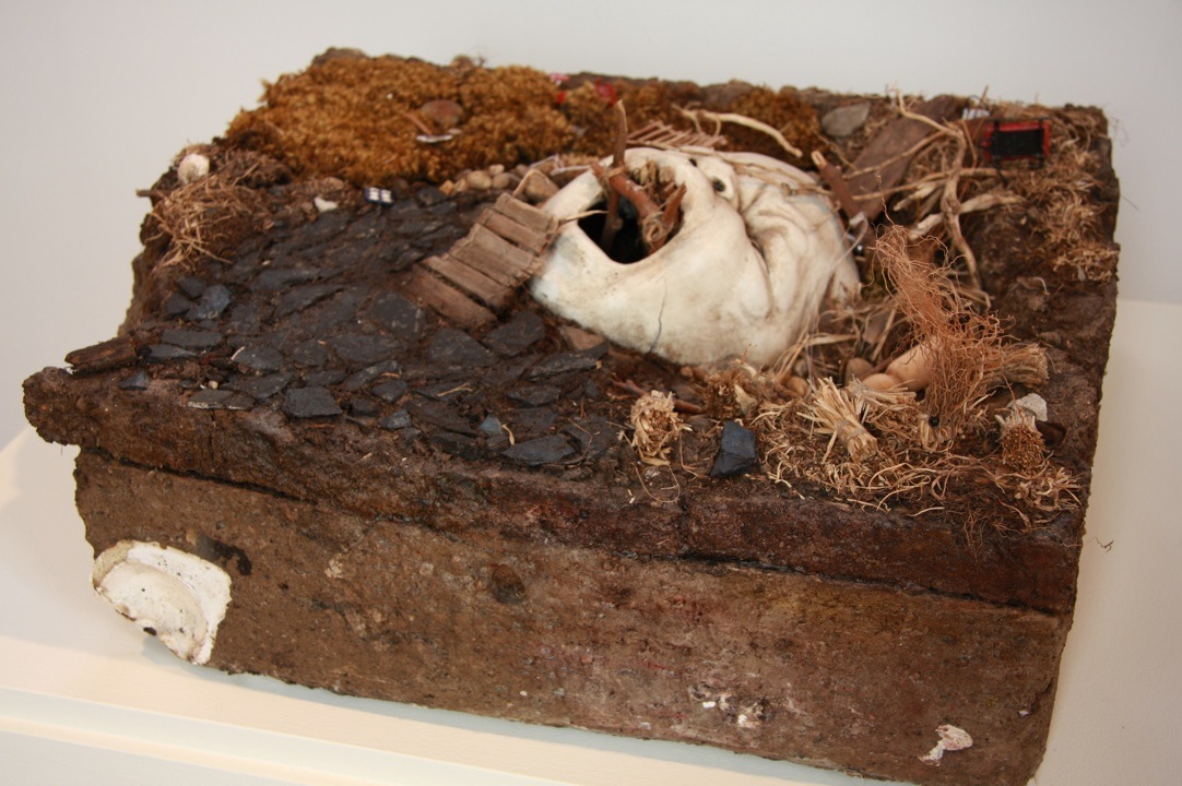 MelanieVote: Refuge in Ruins (2009), maquette made of dirt, plaster, sculpy, other found materials 8x24x36 in.